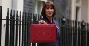 Chancellor Rachel Reeves holding up the famous Red Briefcase in front of 10 Downing Street.